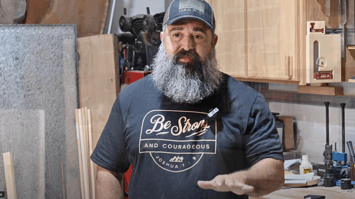 PEP graduate sharing testimonial inside a workshop while wearing a "Be Strong and Courageous" shirt
