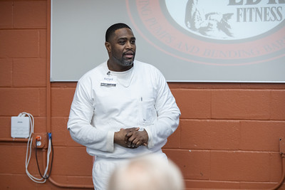 PEP participant presenting a business plan idea to volunteers and executives during a pitch event.