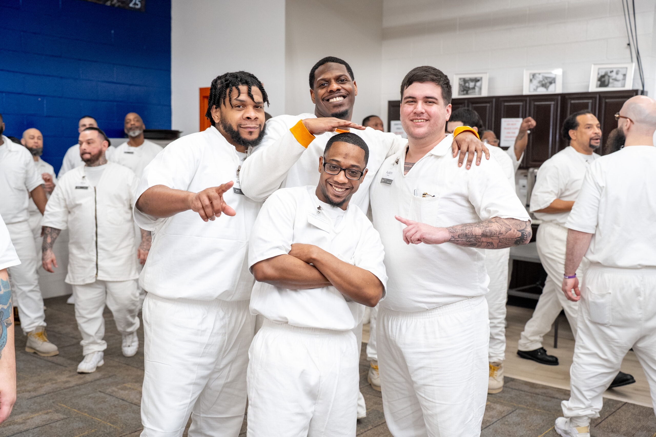 Prison Entrepreneurship Program participants pose together and celebrate brotherhood during a PEP class session inside a Texas correctional facility