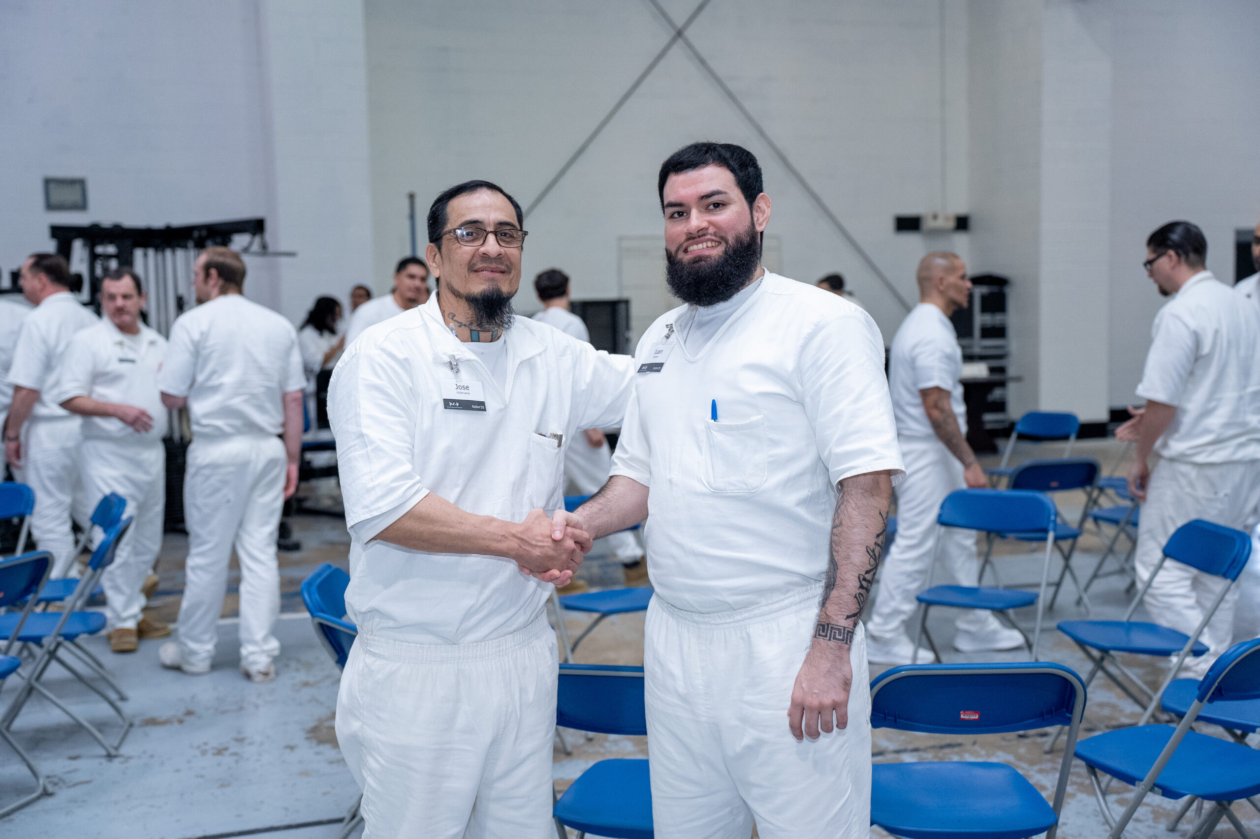 Prison Entrepreneurship Program participants shake hands and connect during a PEP class session inside a Texas prison unit