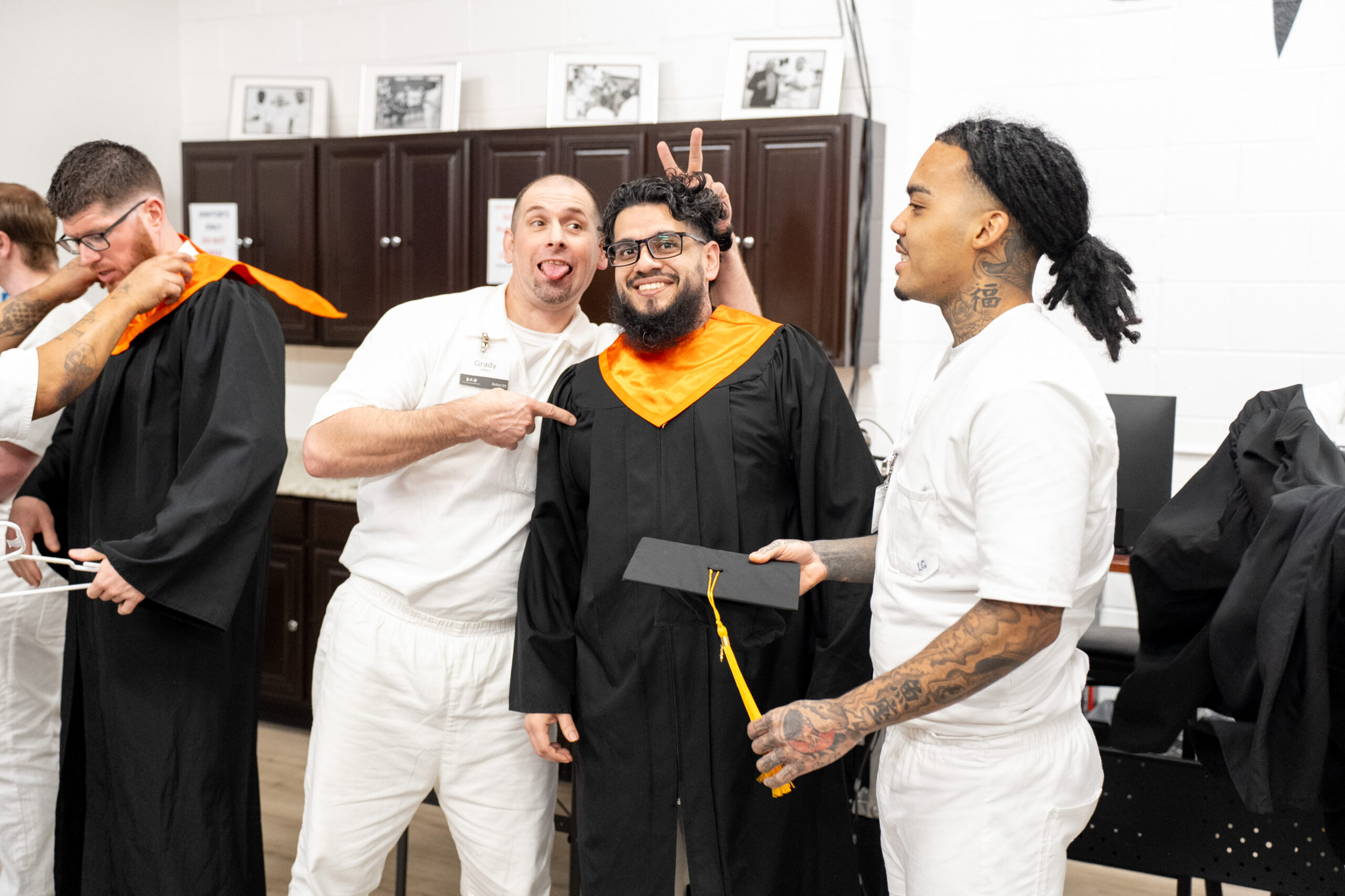 PEP graduates share a lighthearted moment backstage as they prepare for the cap and gown ceremony, smiling and supporting one another before the celebration