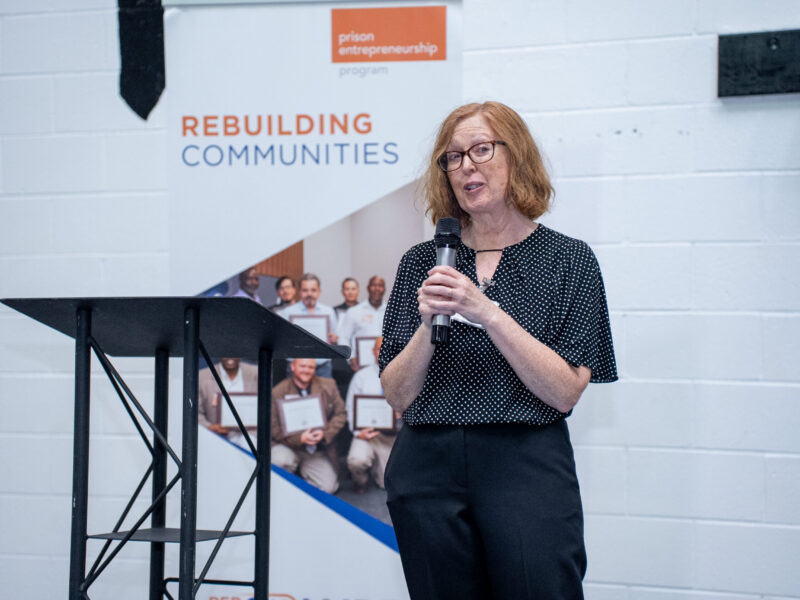 Prison Entrepreneurship Program volunteer speaker shares remarks during a PEP graduation focused on rebuilding communities