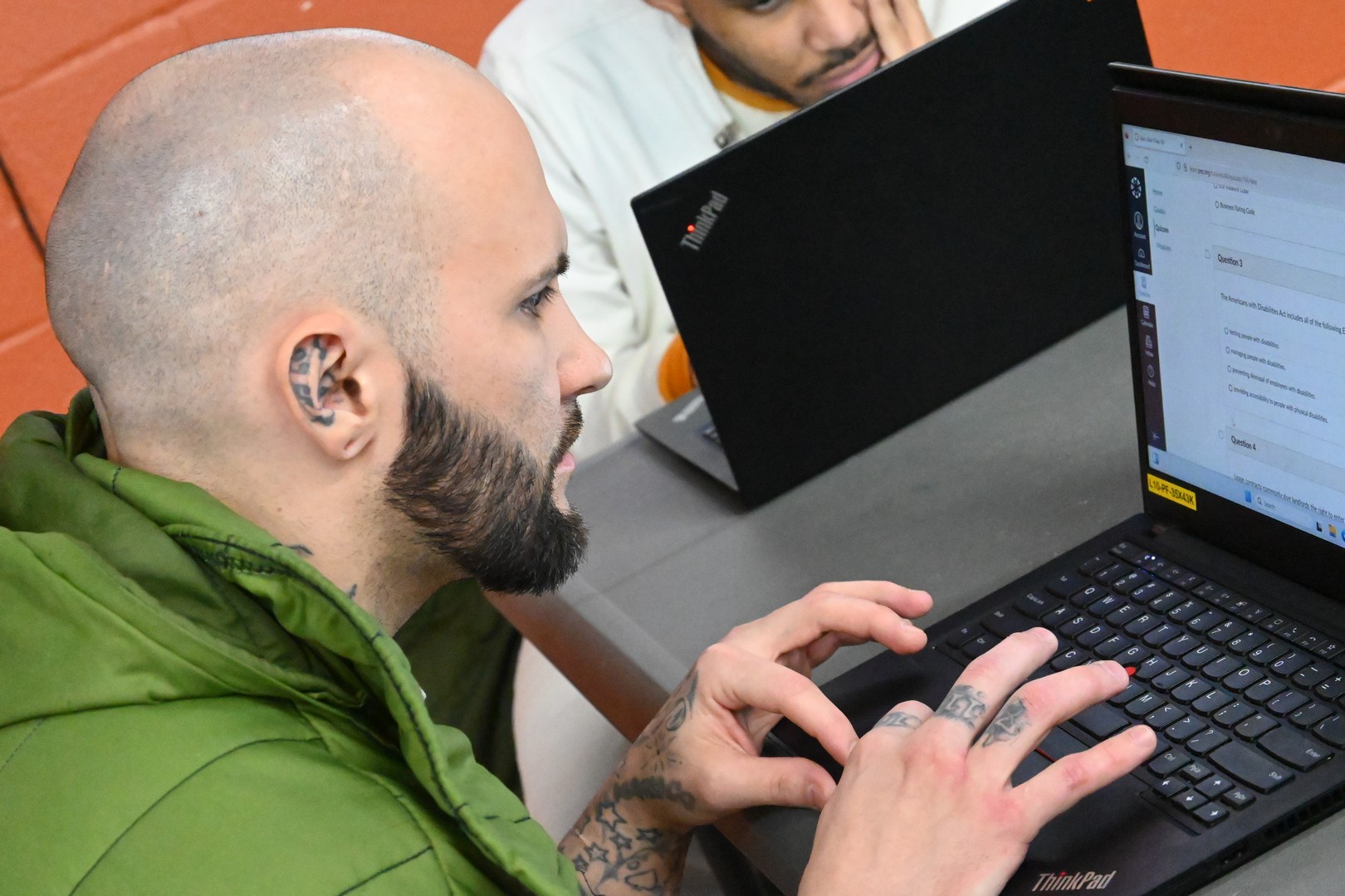 Prison Entrepreneurship Program participant works on a digital business training module during a PEP computer lab session in a Texas prison