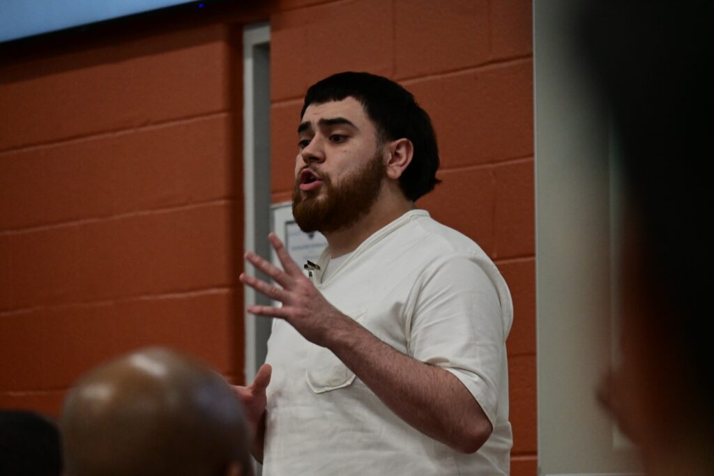 Participant in the Prison Entrepreneurship Program speaks during a Leadership Academy session