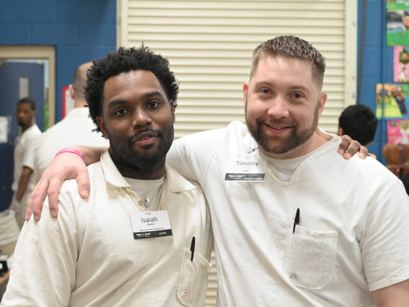 Prison Entrepreneurship Program participants smile and pose together during a PEP class session focused on leadership and transformation