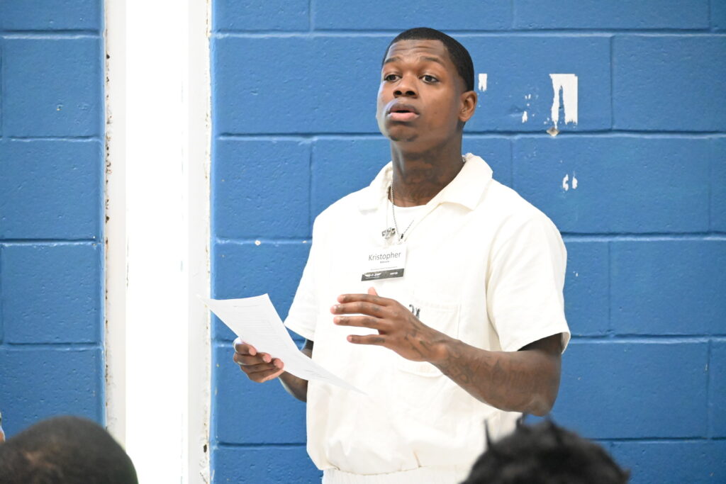 PEP participant Kristopher delivering a leadership presentation during the Prison Entrepreneurship Program, showcasing growth and public speaking skills