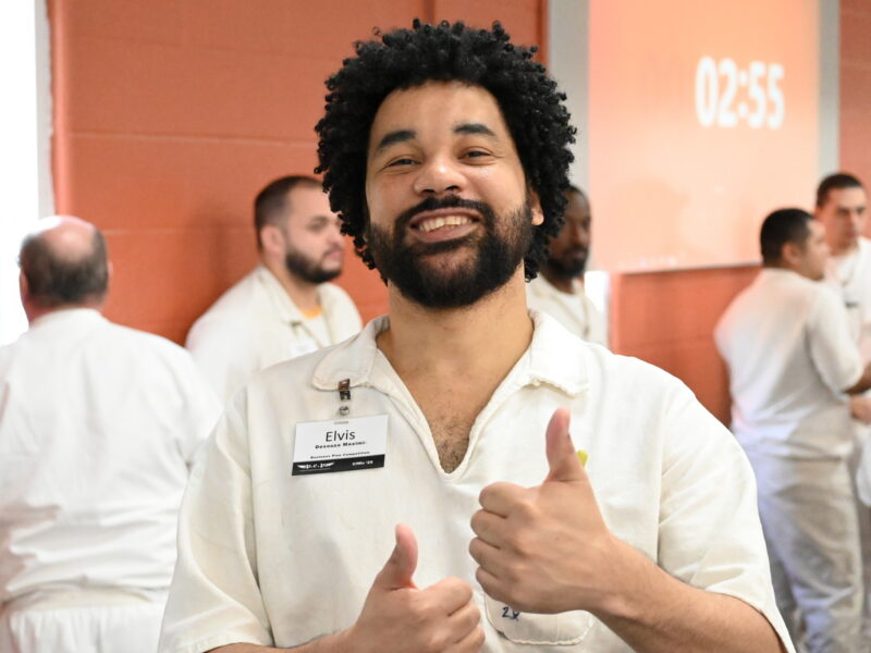 Prison Entrepreneurship Program participant smiles and gives thumbs up during a PEP workshop inside a Texas prison unit
