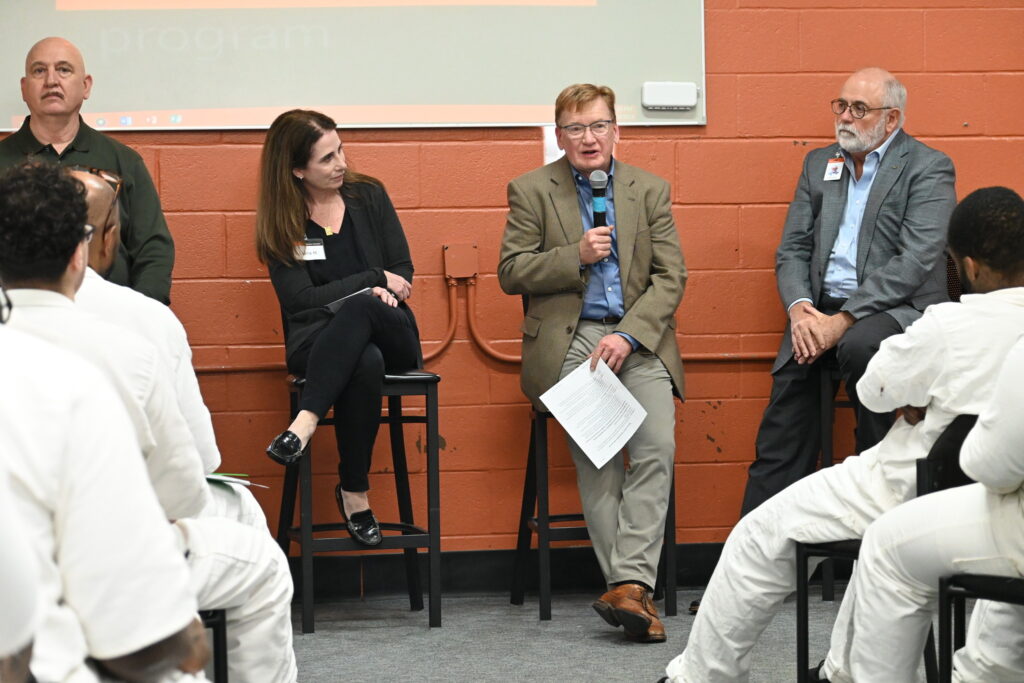 Panel of PEP volunteers and leaders speaking to participants inside the prison program classroom