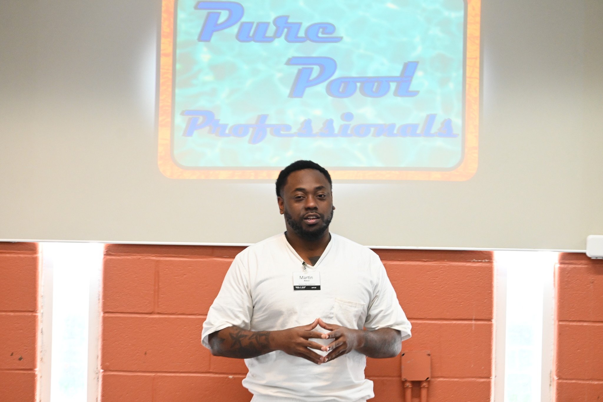 Prison Entrepreneurship Program participant presenting a business plan for Pure Pool Professionals during the Business Plan Competition