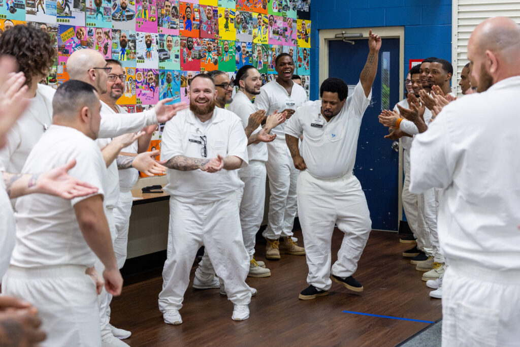 Prison Entrepreneurship Program participants celebrate together during a group activity, building community, confidence, and brotherhood as part of personal transformation and reentry preparation