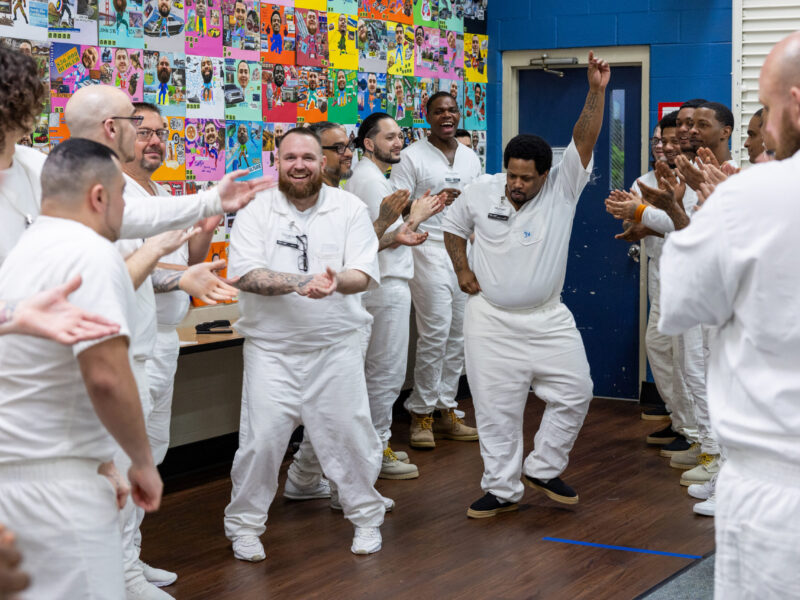 Prison Entrepreneurship Program participants celebrate together during a group activity, building community, confidence, and brotherhood as part of personal transformation and reentry preparation