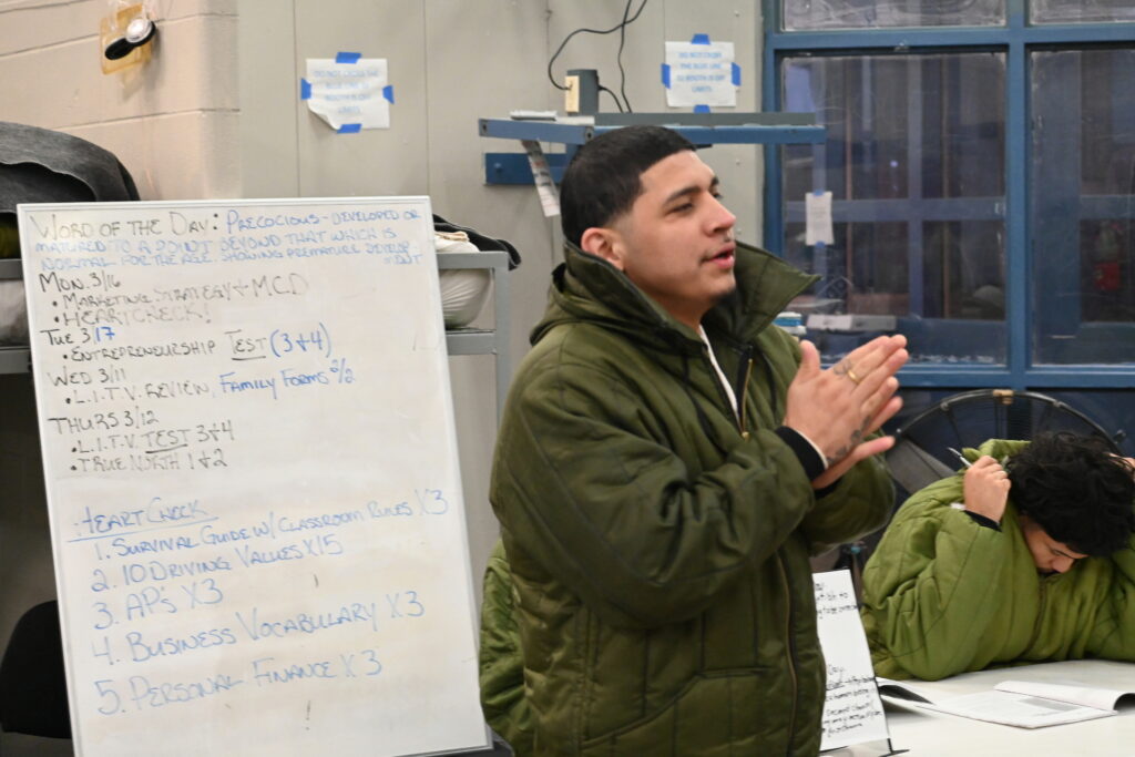Participant in the Prison Entrepreneurship Program speaks during a classroom session, developing leadership, communication, and business skills as part of PEP’s reentry preparation model
