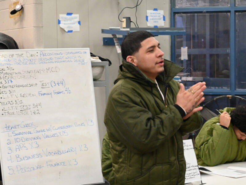 Participant in the Prison Entrepreneurship Program speaks during a classroom session, developing leadership, communication, and business skills as part of PEP’s reentry preparation model