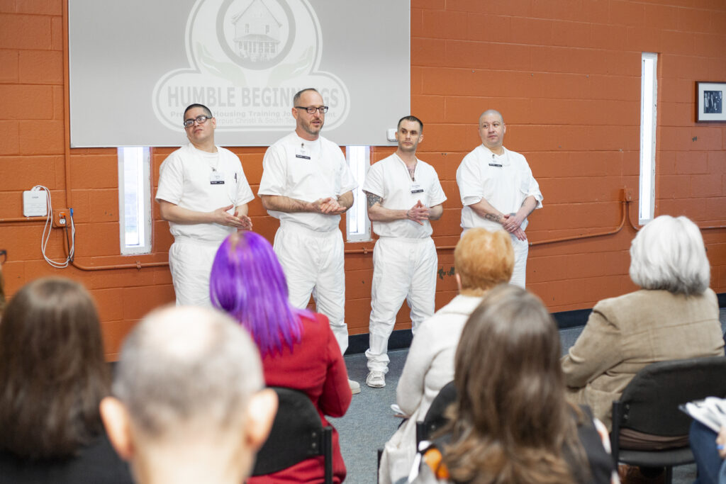Participants in the Prison Entrepreneurship Program Business Plan Competition present their ventures to an audience, demonstrating public speaking, business development, and readiness for reentry through entrepreneurship